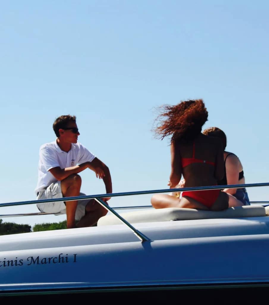 An Image of 3 people siting on a yacht